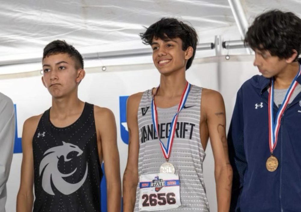 Junior Kai McCullough smiles for a picture after placing 6th in the Cross Country state championship. 